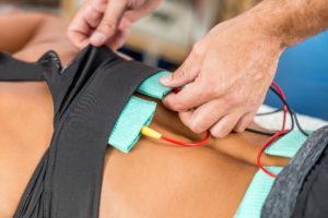 Electrical stimulation in physical therapy. Therapist positionin